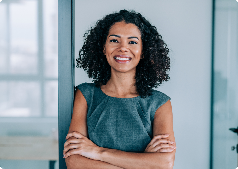 Person smiling with crossed arms